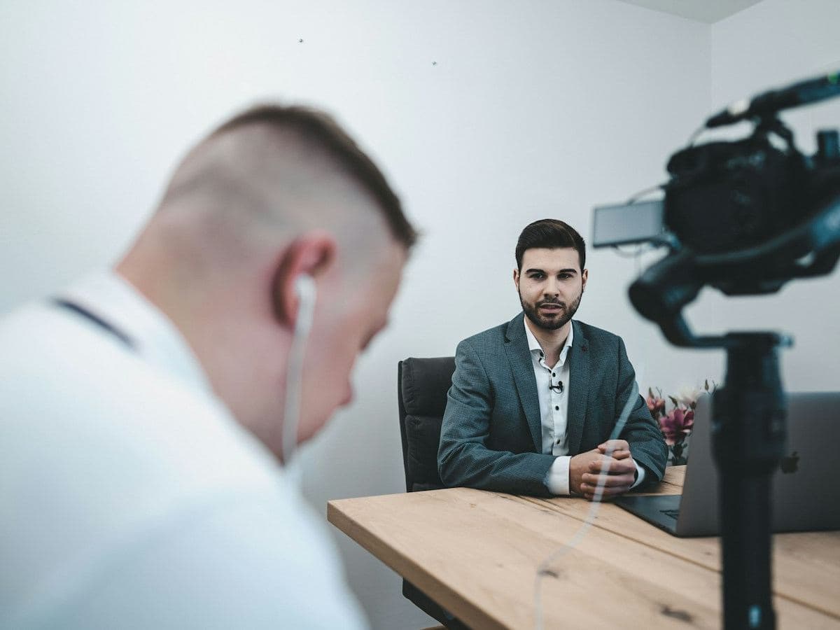 Camera crew filming an interview in an office